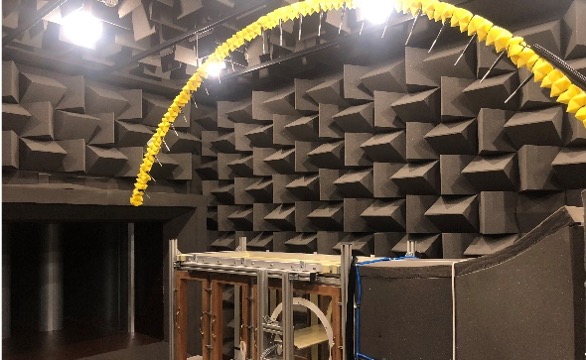 This picture shows the new aero – acoustic wind tunnel facility at the University of Bristol which is part of the National Wind Tunnel Facility.  The wind tunnel can be used to measure the generation of noise as the air flows past scaled aerospace structures.  The characteristic shape of  the walls enclosing the tunnel ensures that there is no reflected noise.